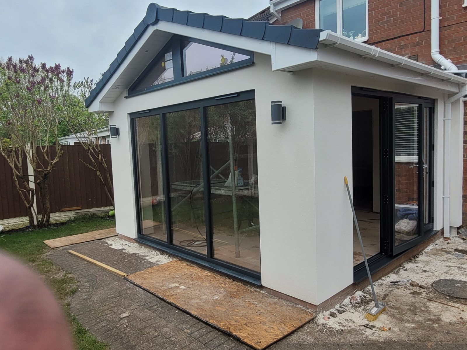 Rendered single storey extension with corner bifold doors by Longmore Construction