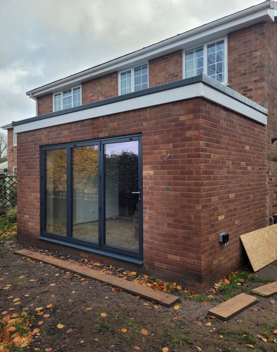 Single storey brick extension with anthracite sliding doors