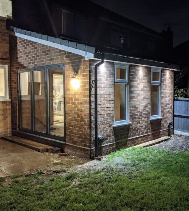 Single storey rear extension finished and lit up at night