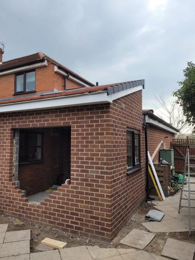 New single storey extension shell built up with the window and door openings formed