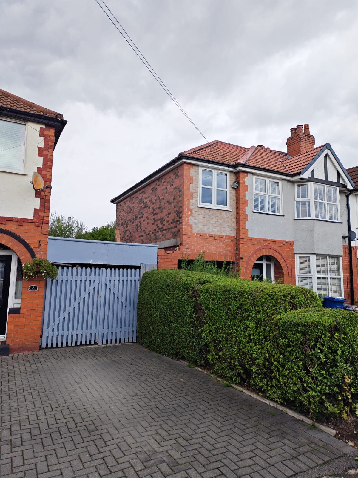Two storey side extension finished in matching brick with the roof tiled in