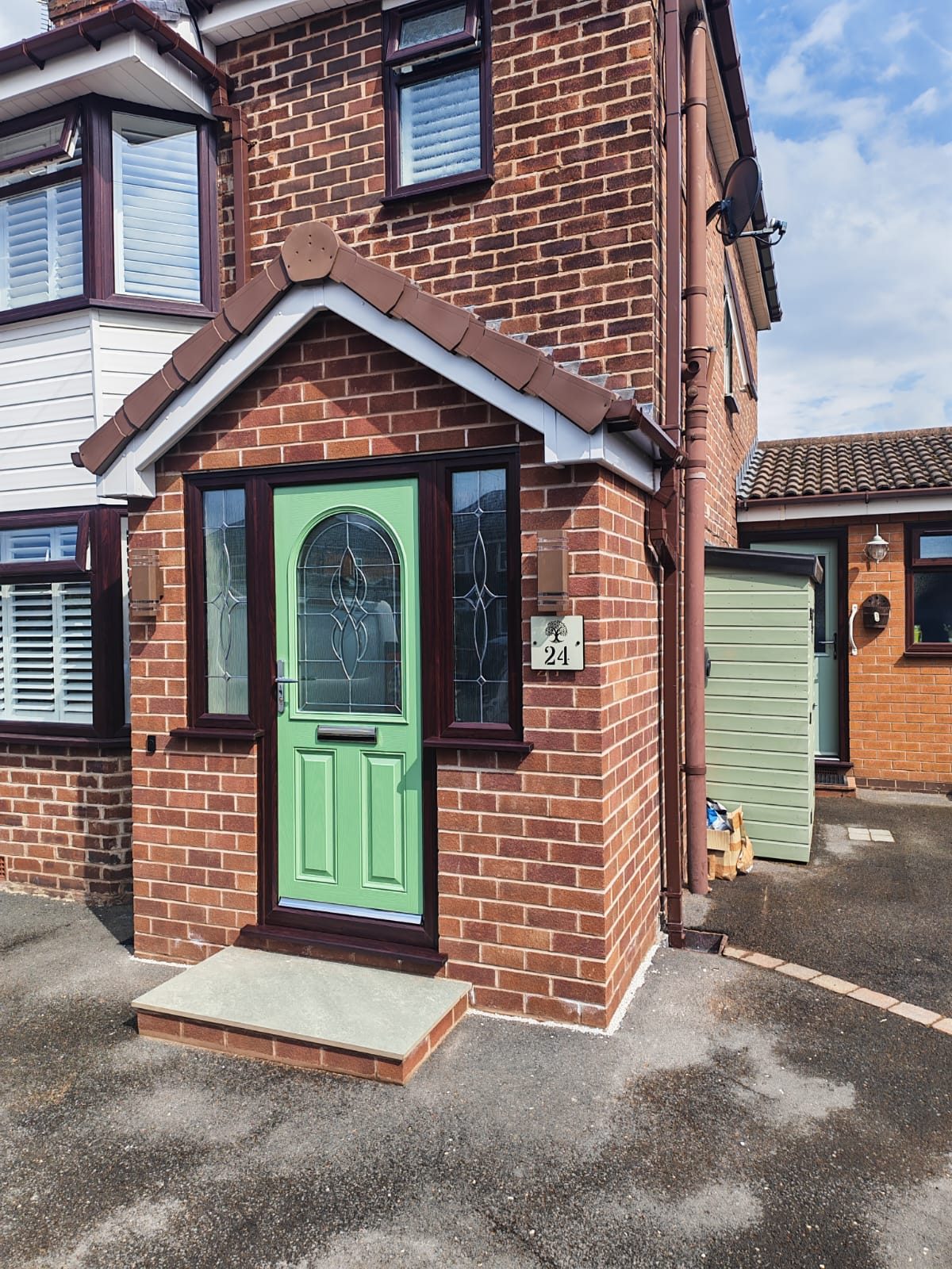 New brick porch with a green composite door and a stone step